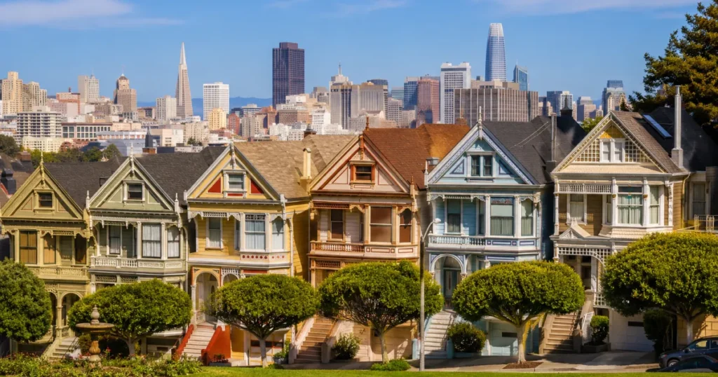 Victorian houses with city skyline backdrop